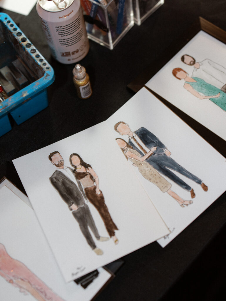 Live watercolor wedding portraits of couples displayed on paper