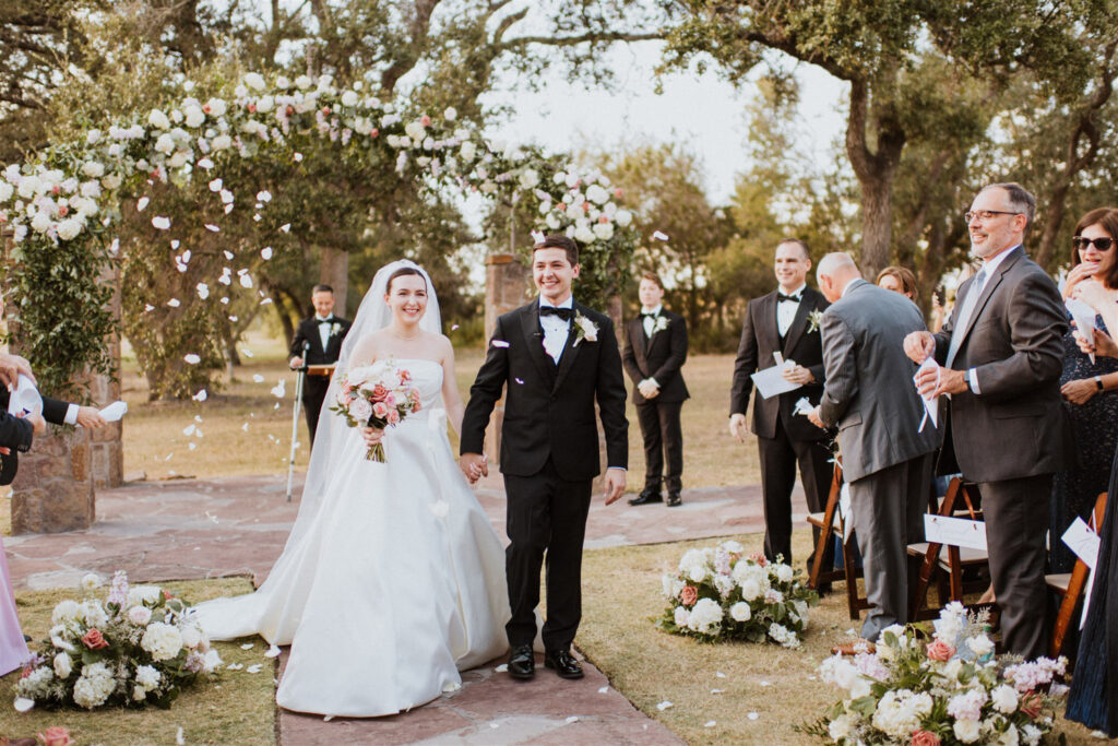 Wedding exit with floral petal toss embracing 2025 wedding trends