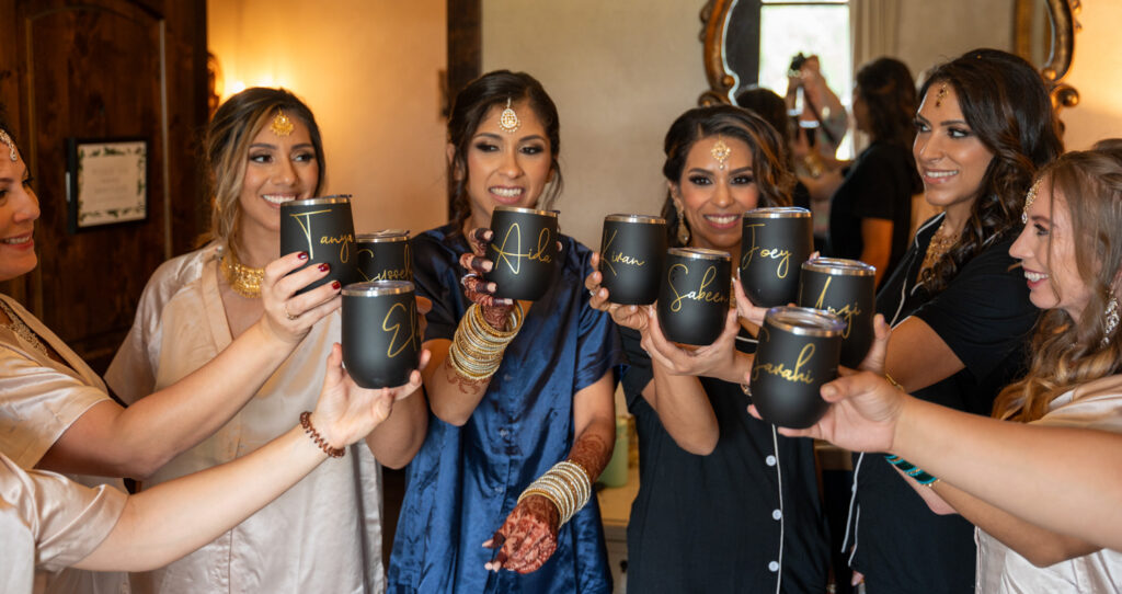 wedding party drinking from travel champagne cups while getting ready