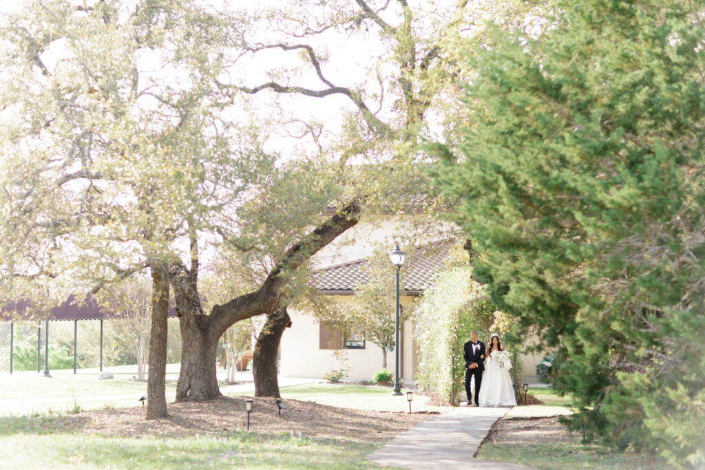 bride and father of the bride walking down cement path at Ma Maison wedding venue
