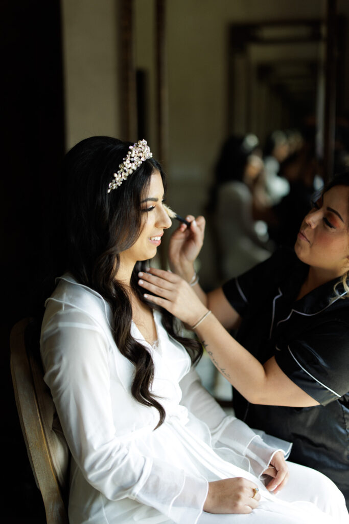 Ashley getting her makeup done before her wedding at Ma Maison wedding venue