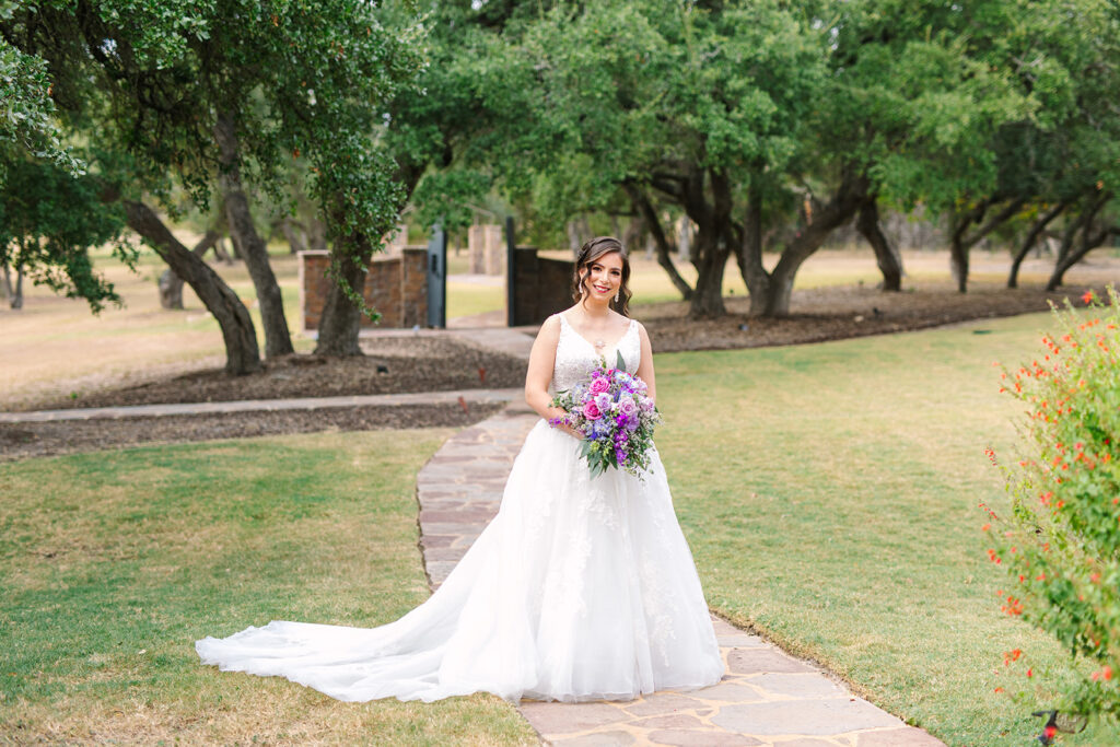 Beautiful bride holding her wedding bouquet outdoors