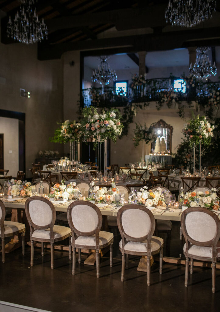 Romantic reception setup with elegant florals and candlelit tables