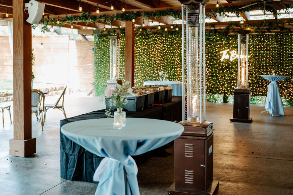 cocktail table covered with blue tablecloth at Ma Maison wedding venue