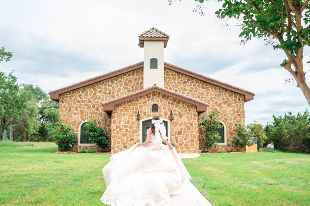 Bride running towards the Chapel of Ma Maison, a luxurious Wedding venue