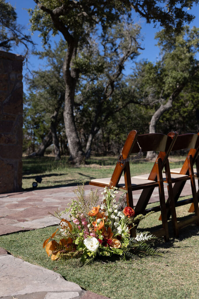 ceremony chairs and florals at Ma Maison 