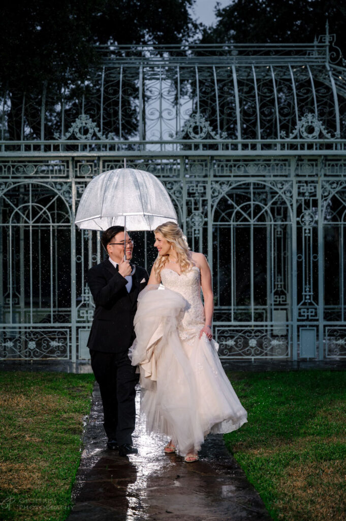  A couple shares a magical moment in the rain at Ma Maison, showcasing the venue’s charm in any weather.