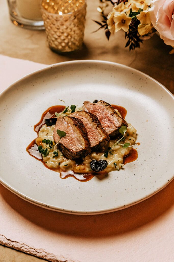 A perfectly cooked steak served over creamy risotto, a mouthwatering dish