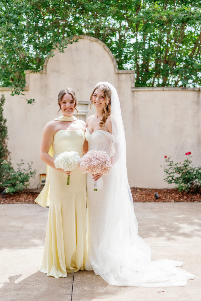Bride with bridesmaid in pale yellow dress