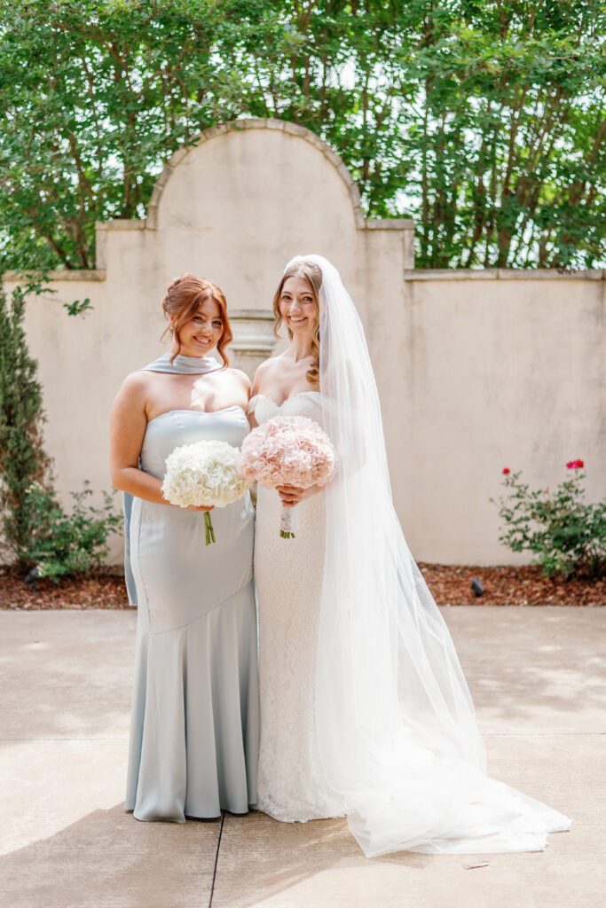 Bride with bridesmaid in light blue dress