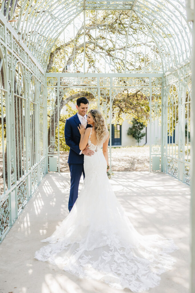Bride and groom sharing a romantic moment in an elegant Green Cathedral