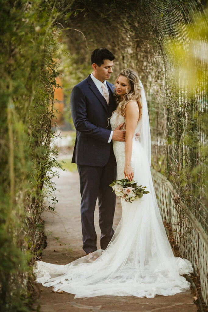Couple posing in the Tunnel of love at a Dallas wedding venue near Austin