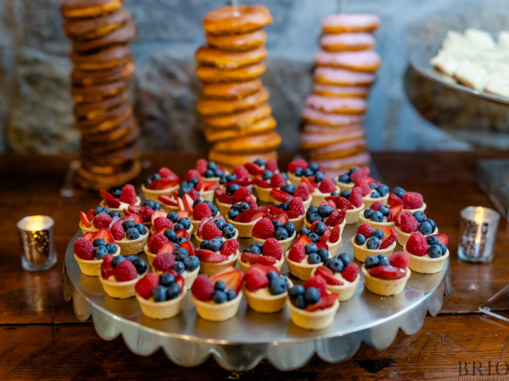 fruit desserts and donuts at wedding reception