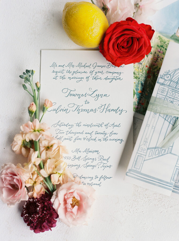 Handwritten wedding vows surrounded by colorful flowers and a lemon.