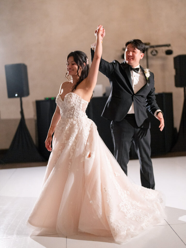 Bride and groom dancing inside the reception hall at Ma Maison