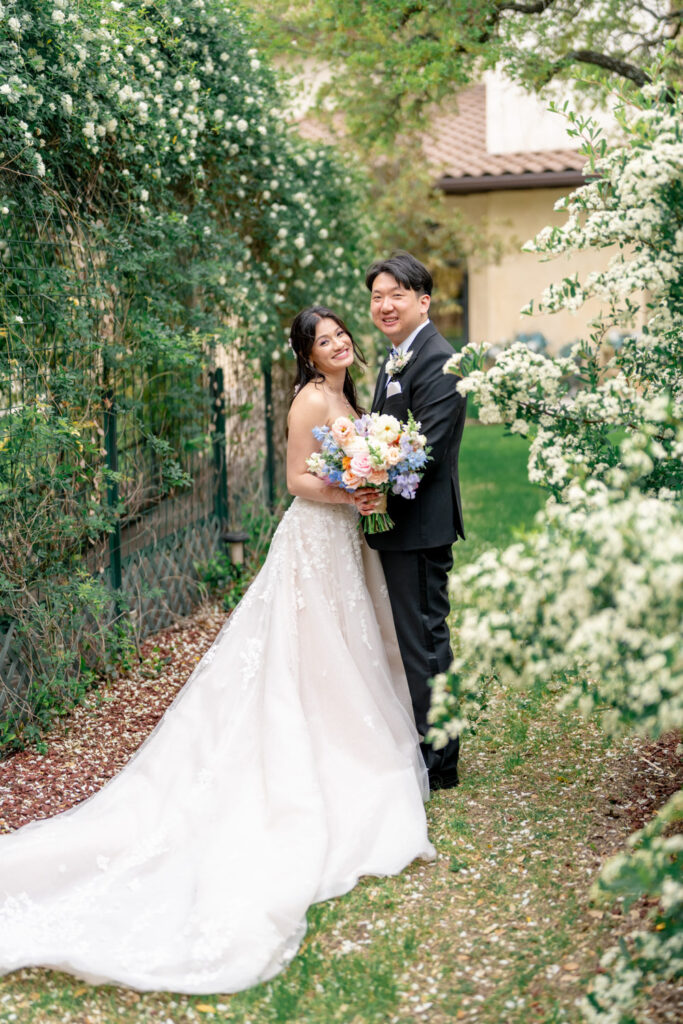 Couple posing in an intimate garden walkway at Ma Maison