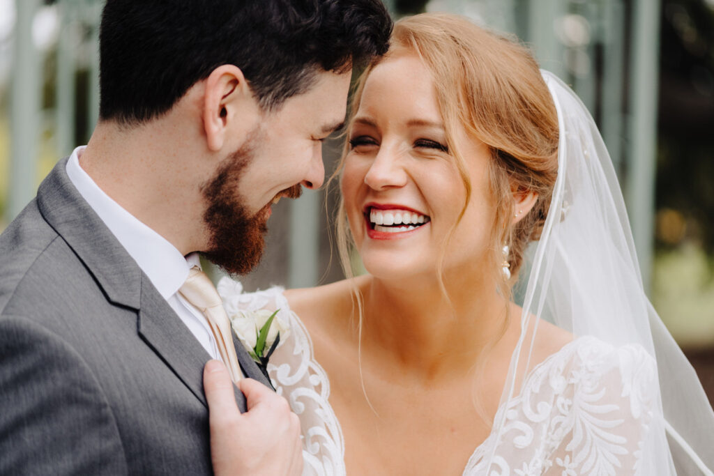 Bride laughing with her groom after getting ready with a top-rated hair and makeup artist in Austin for their wedding day.