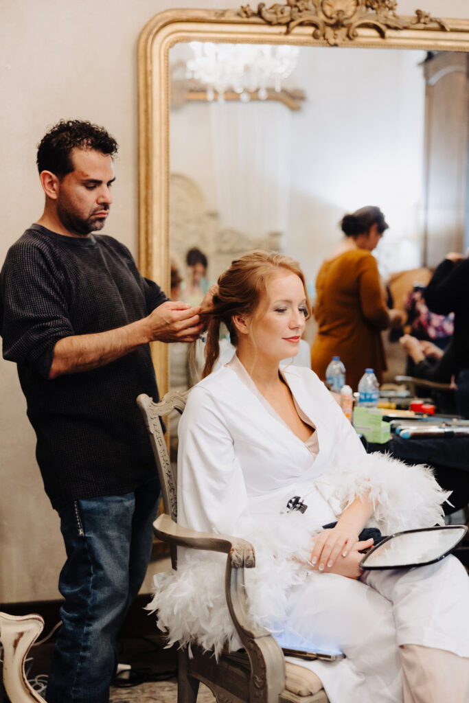 Bride getting her wedding hairstyle done by an experienced hair and makeup artist.