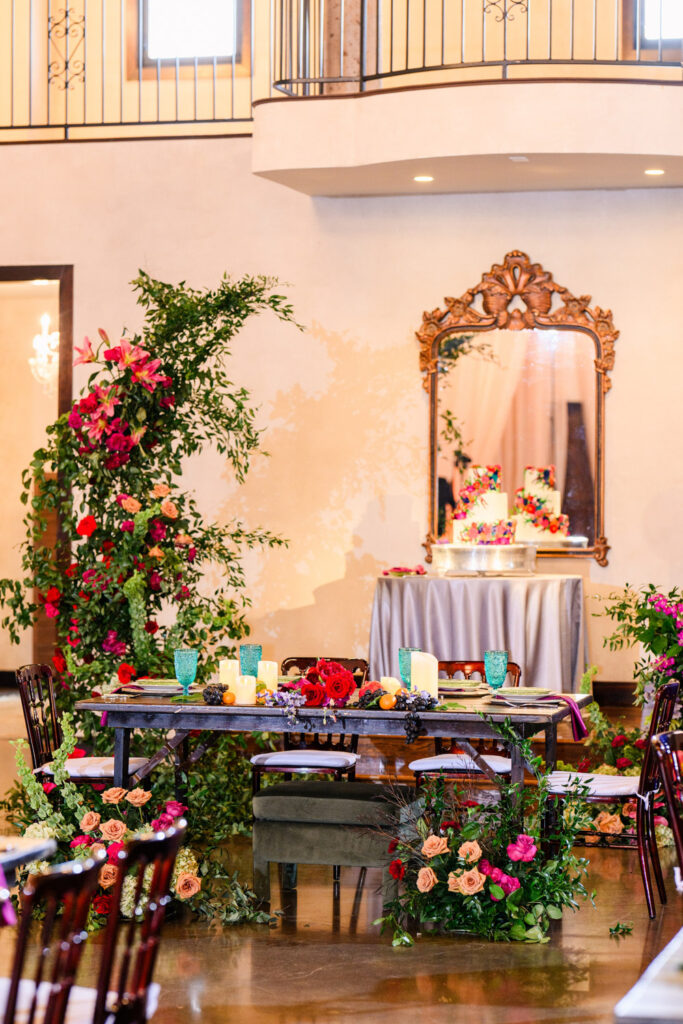 Romantic sweetheart table with vibrant floral installations at an intimate wedding venue in Austin.
