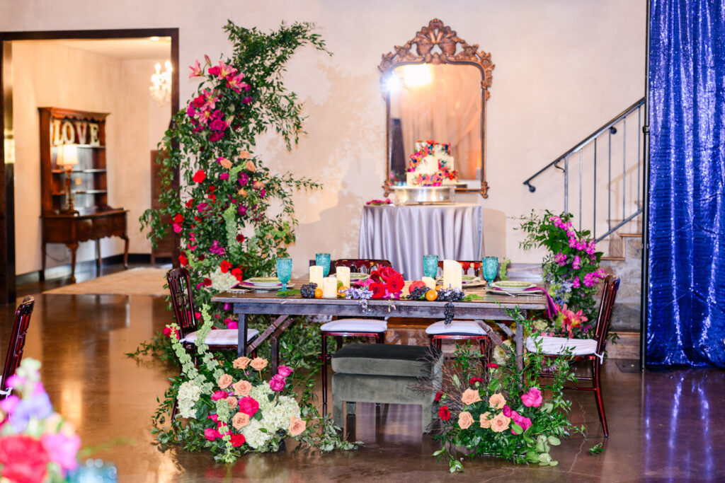Colorful floral-decorated reception setup inside an intimate wedding venue