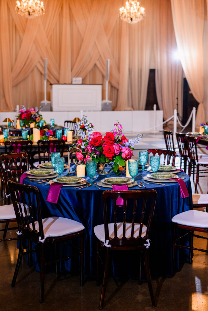 Vibrant floral centerpiece and table setting at an intimate wedding venue in Austin