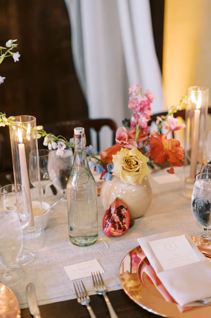 A beautifully styled wedding table at Ma Maison adorned with fresh florals, candlelight, and luxurious place settings.