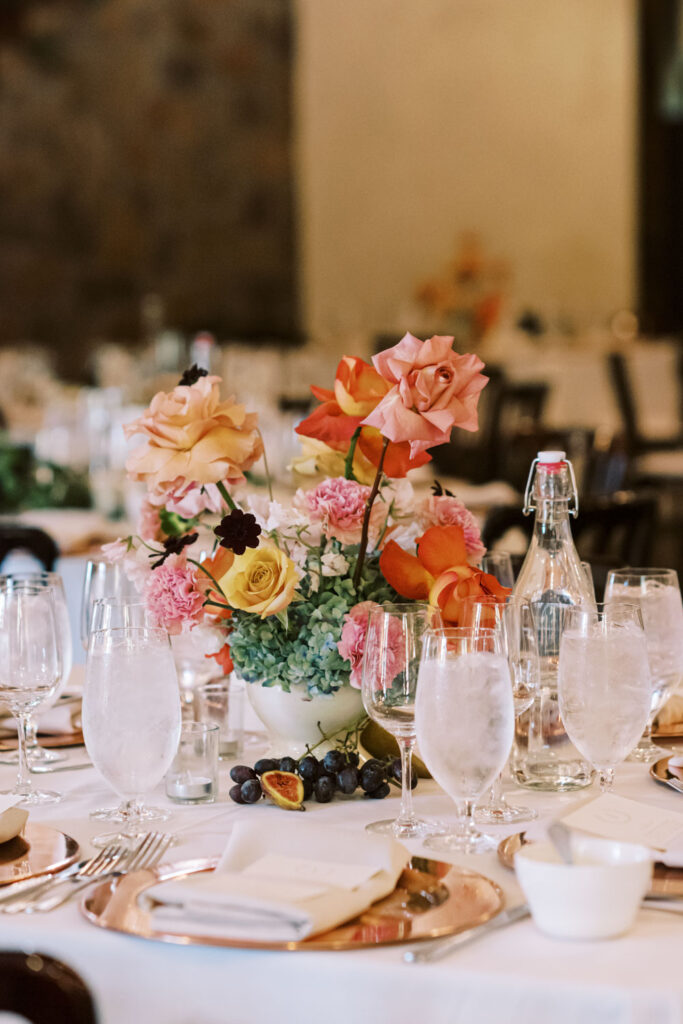 A stunning floral arrangement decorates a wedding table at Ma Maison offering European-inspired romance and charm