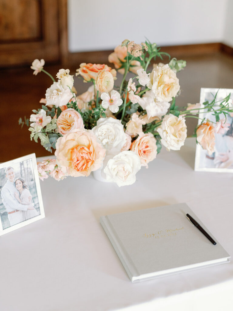 coral and white florals with guest book at wedding