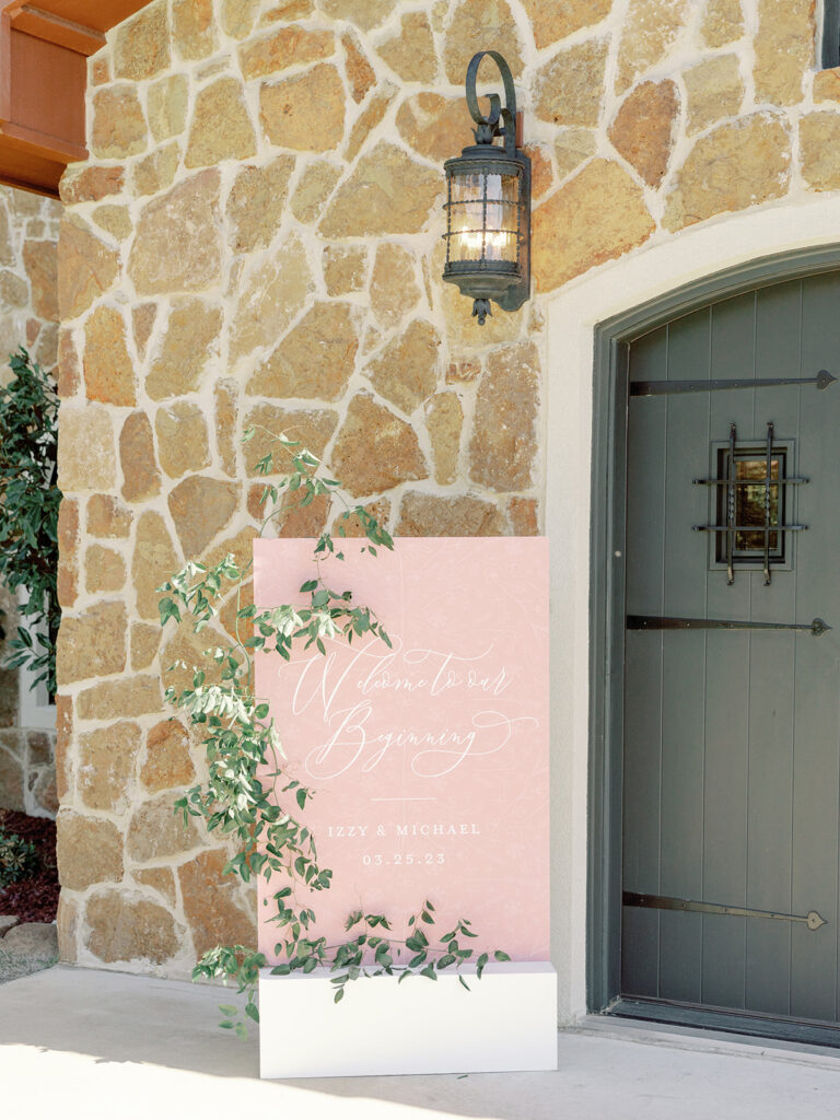 wedding entrance sign outside of front door at Ma Maison wedding venue in Dripping Springs, Texas