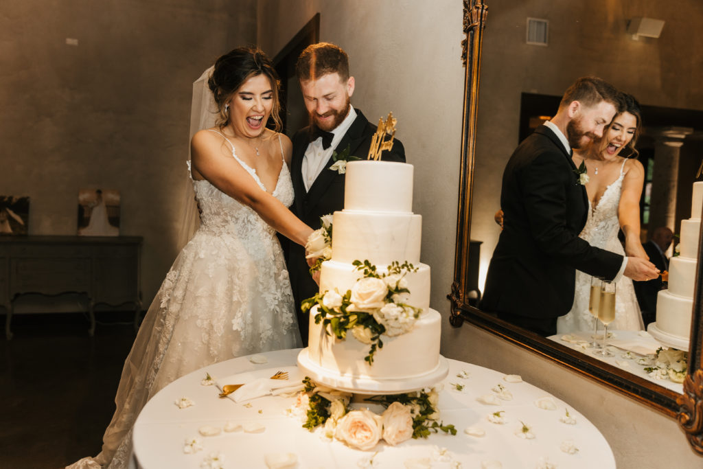 bride and groom cut cake on their Texas wedding day