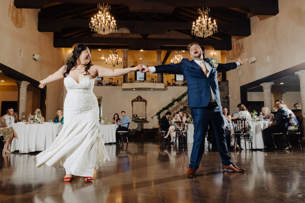 Couple holding hands during their reception dance