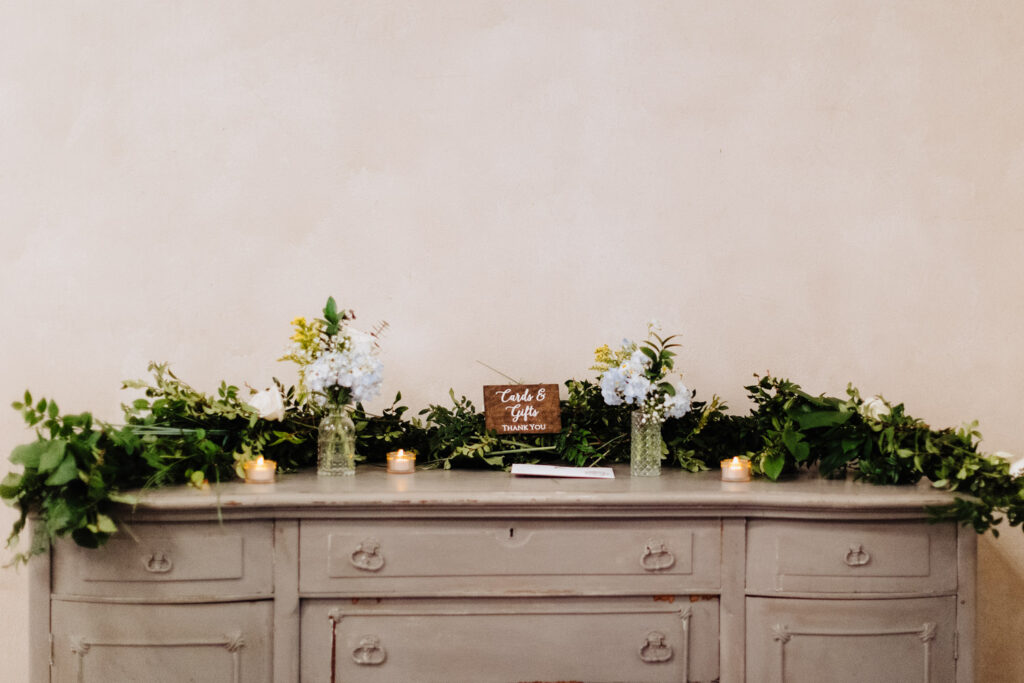 Greenery and white floral display on a reception table