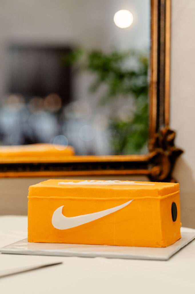 Nike themed orange shoebox cake