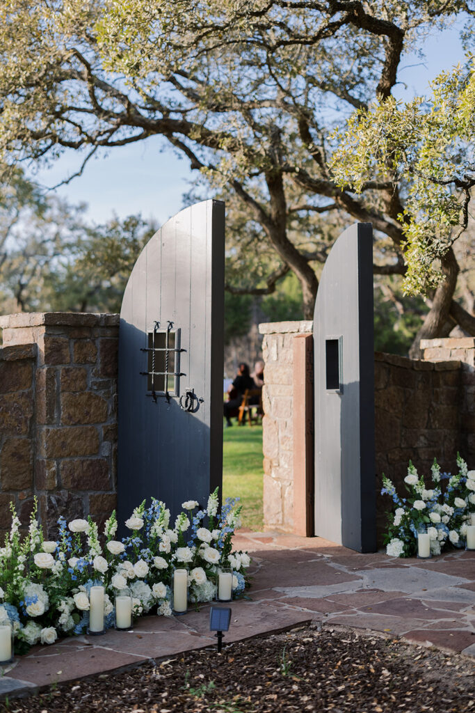 tone entry gate decorated with white and blue flowers