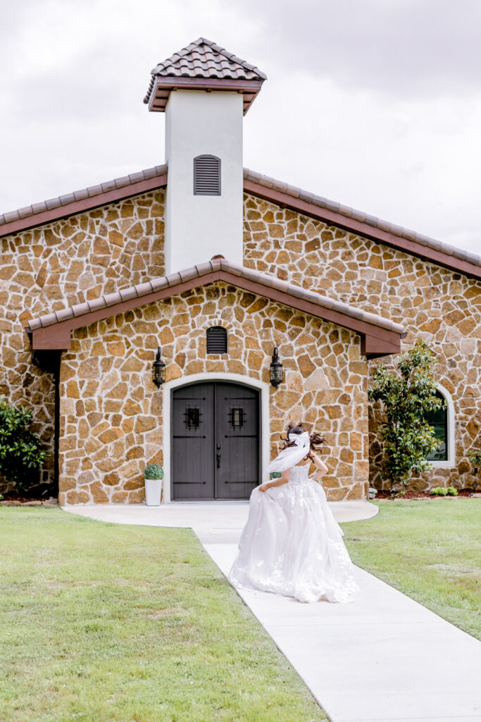 bride running to Ma Maison wedding venue in Dripping Springs, Texas