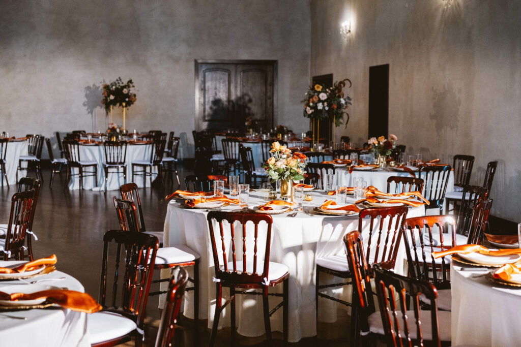 Reception layout with orange details at Ma Maison wedding venue