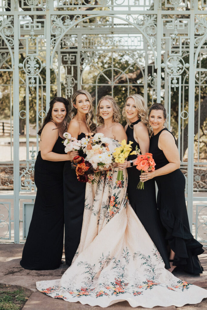 Bride in floral gown with bridesmaids