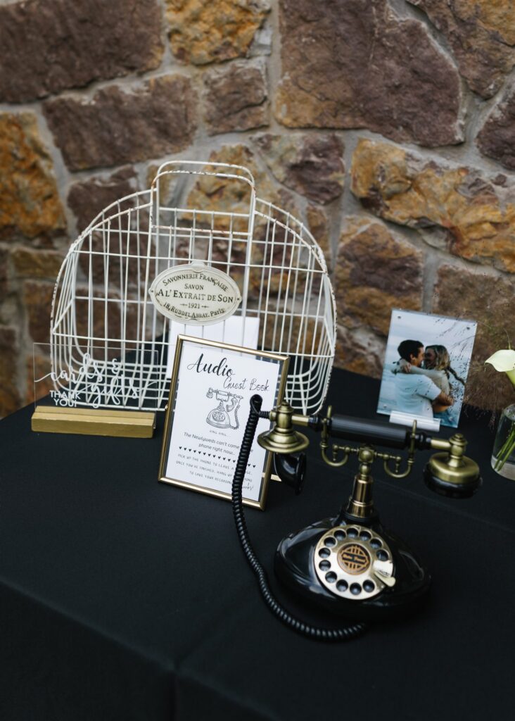 Wedding audio guestbook station with vintage phone and sign