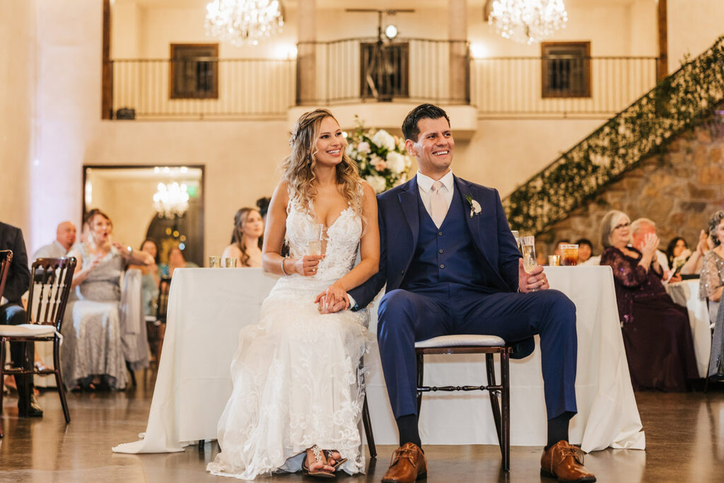 Newlyweds smile together during their indoor reception showcasing Sustainable Wedding Venues in Austin
