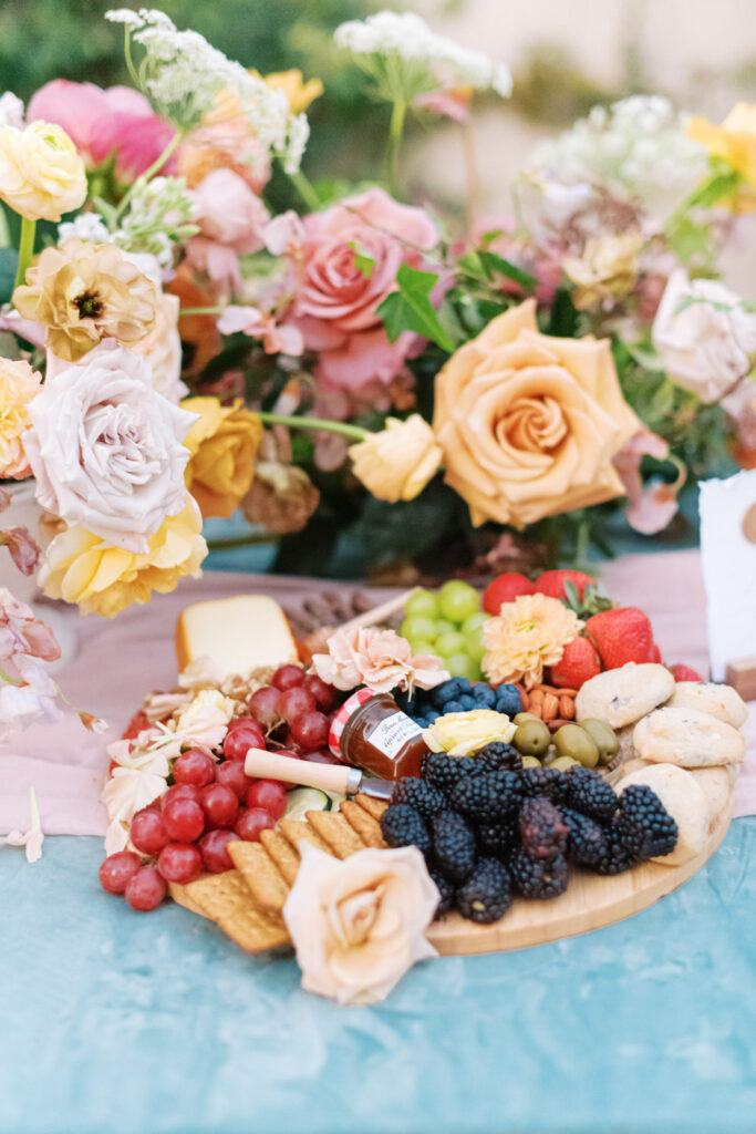 Wedding charcuterie display with floral centerpiece and place cards