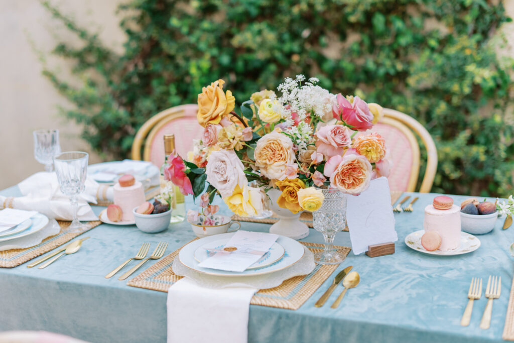 Romantic wedding reception table with colorful roses and decor