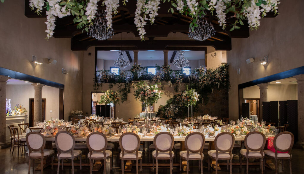 Elegant reception hall with chandeliers and floral décor Taylor & Travis Inspired Engagement Party Ideas