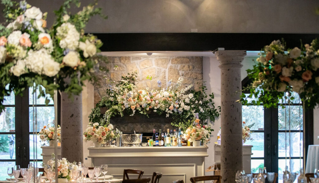 Wedding bar decorated with lush floral arrangements