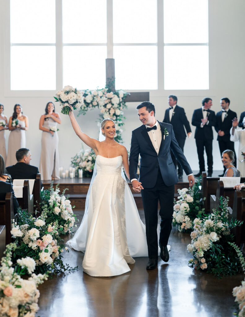 Bride and groom walking up the aisle after their ceremony