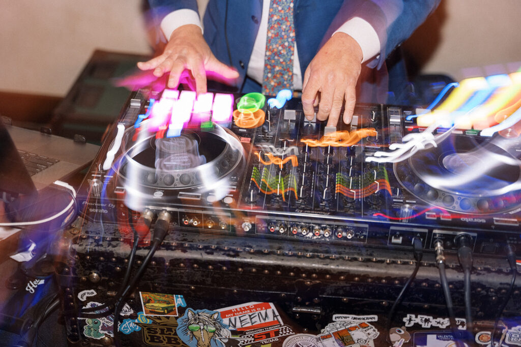 Hands-on mixing board in action during a vibrant Austin wedding reception.