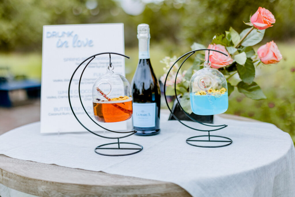 Wedding drink display with champagne, cocktails, and pink roses