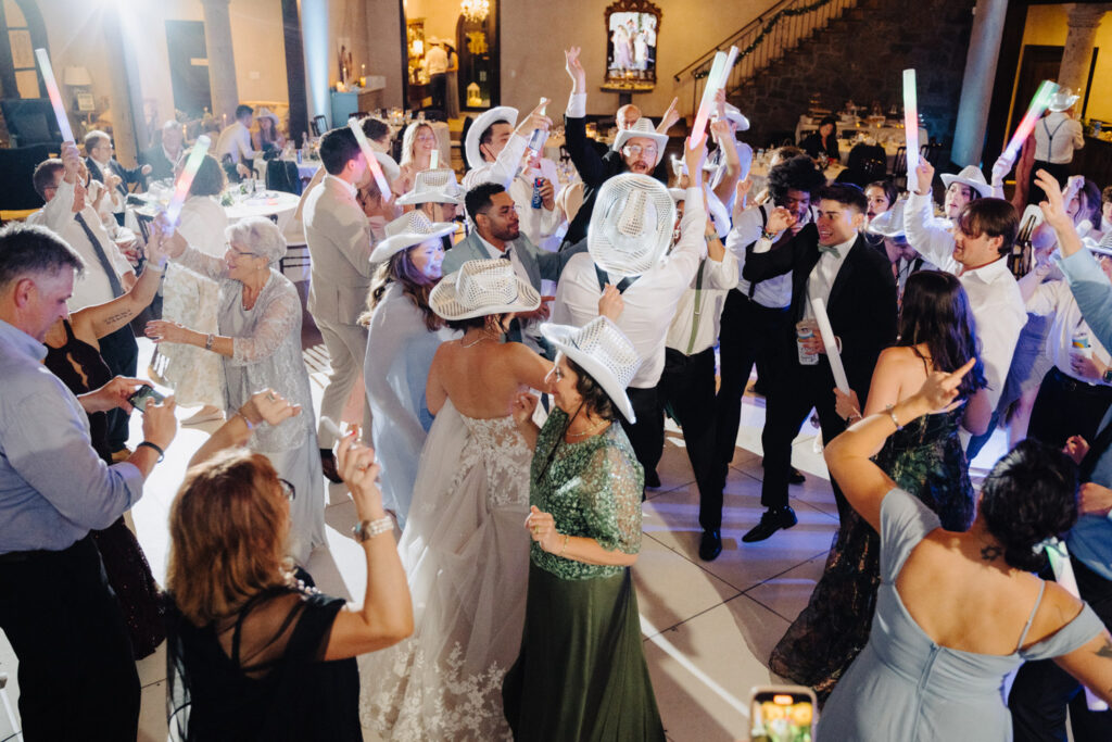 Newly married couple and guests having fun dancing at the party
