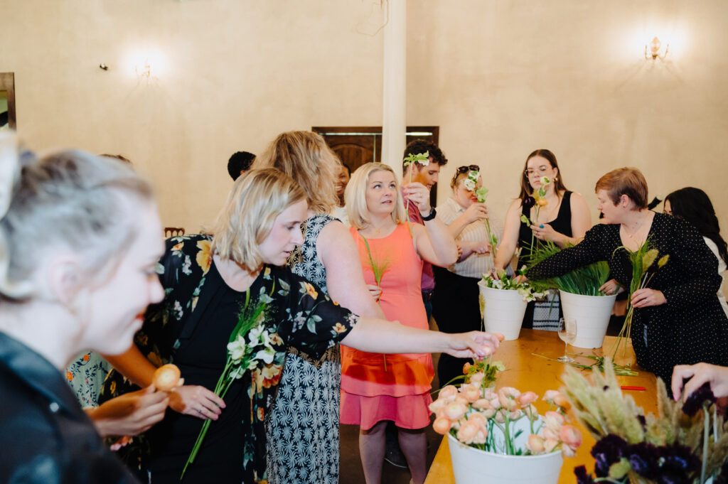 Guests creating bouquets with help from a wedding planner in Austin