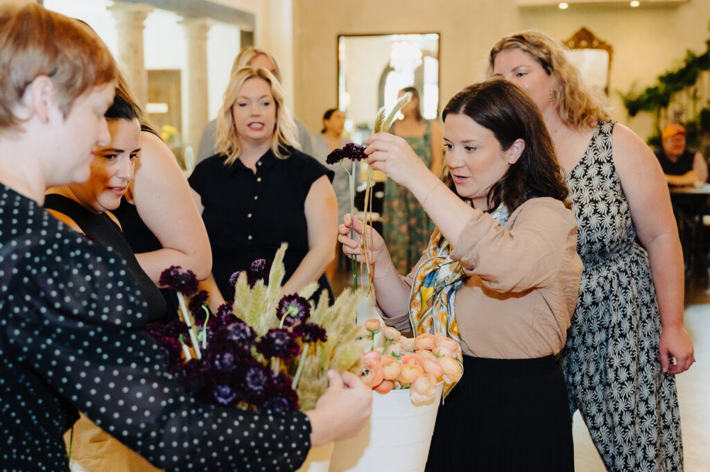 Wedding planner in Austin assisting guests with floral designs