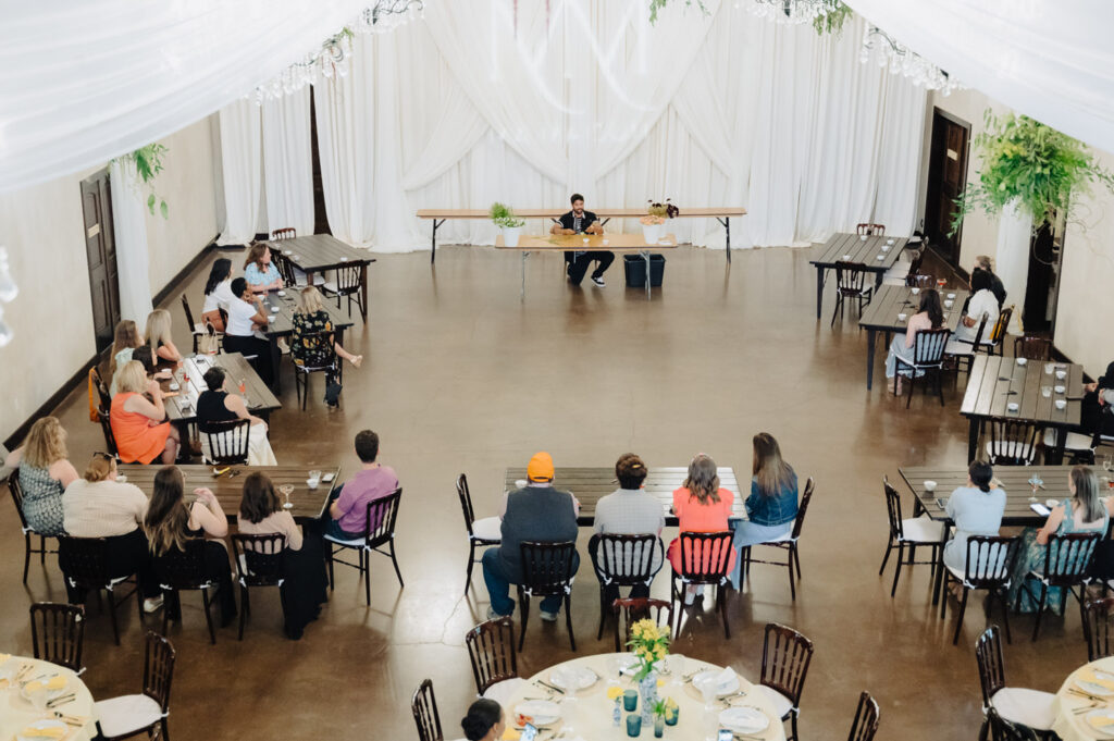 Guests watching a floral demo led by a wedding planner in Austin